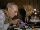 Man Makes a Miniature of an English Crown While a Cat Watches