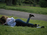 Young Couple Embracing While Lying in the Grass