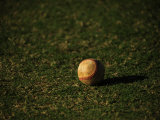 Baseball Casts a Shadow on Grass