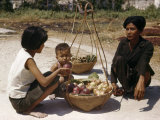 Woman with a Boy Asks a Vendor for the Price of a Rose Apple