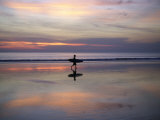 Sunset on Kuta Beach  Surfers Carry their Surfboards from the Ocean