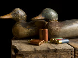 Antique Duck Decoys and Shotgun Shells Sit on an Old Wooden Crate