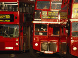 Travelers on Traditional Red Buses in London
