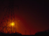 Sun Sets Behind Power Lines Stretching Off into the Distance