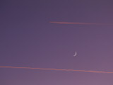 Jet Vapor Trails in a Clear Sky with the New Moon
