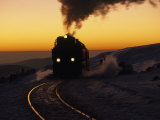 Train Rounding a Bend in the Tracks at Sunset