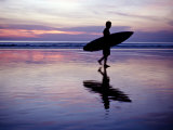 Surfer Walks across the Beaches of Kuta Beach in Bali
