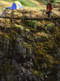Backpacker Exploring a Suspension Bridge by His Tent