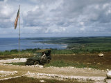 Soldier Sits in a Jeep on Hillside Overlooking Remains of Tinian Town