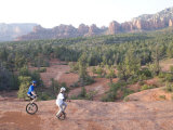 Two Men on Unicycles Ride a Rocky Ridge in the Arizona Desert