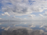 Clouds and Sky are Reflected in Calm Water with Bridge