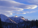 Scenic Mountain Landscape with Evergreen Trees and Clouds Overhead