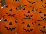 Colorful Plastic Jack-O-Lanterns Grin at the Approach of Halloween
