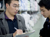 Factory Employees Discuss Textile Inventory