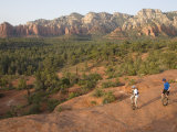 Two Men on Unicycles Ride a Rocky Ridge in the Arizona Desert