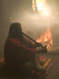Native American Smoking a Peace Pipe in an Earth Lodge