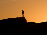 Silhouetted Hunter at Twilight Looking for Narwhals