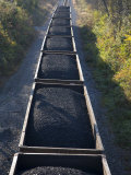 Train Cars Filled with Coal Travel the Rails