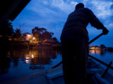 Boatman Paddling over to the North Side of the Sarawak River