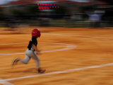 Boy Runs During a Baseball Game at Night