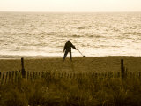 Dawn Beachcomber Uses a Metal Detector to Search for Lost Coins