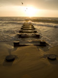 Atlantic Ocean Waves Break Against Pilings at Sunrise