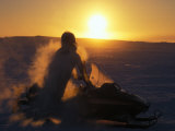 Inuit Hunter on a Snowmobile at -40 Degrees Celsius  at Sunset