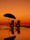 Picturesque Scene with Two Chairs and an Umbrella on the Beach