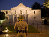 Rear View of a Texas Ranger Standing in Front of the Alamo at Twilight