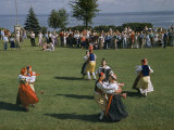 Folk Dancers in Swedish Costumes Swirl around an Accordion Player