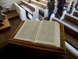 Open Bible and Tourists in a Small Local Church