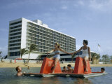 Tourists Pedal Raft Pass Swimmers at Oceanside Resort