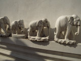 Wooden Carvings of Elephants Adorn the Edges of a Temple Complex