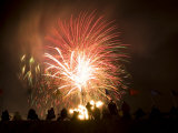 Group of People Watch Fireworks Light Up the Sky at a Fiesta