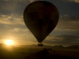 Hot Air Balloon in Flight at Dawn over the Namib Desert