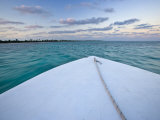 Bow of a Boat Sails Toward a Tropical Sunset