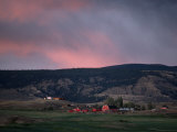 Farm Landscape with Red Barn and Hills at Twilight
