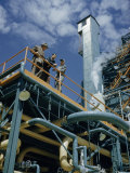 Men Stand on Deck of Gas-Powered Power Station