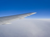 Airplane Just Above Clouds with Sky Split in Blue and White Layers