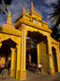 Person on Bicycle at a Laos Temple Entrance