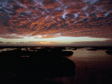 Dramatic Clouds over Water and Beach at Sunset