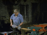 Man Uses a Grinding Disk to Finish the Production of Anvils