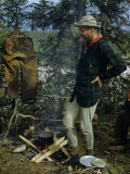 Man Stands by a Campfire in Long Underwear While His Pants Dry