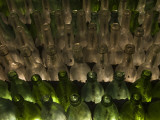 Rows of Clear and Green Bottle Lie on Top of Each Other