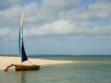 Boy Pushes a Dhow Seaward Along Banguerra Island in Mozambique