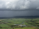 Ominous Rain Clouds Roll over Landscape Toward Town and Sugar Mill