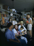 Townsfolk Linger and Shoppers Shop at a General Store