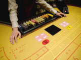 Dealer at a Hotel Casino Awaits Players for a Game of Baccarat