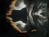 Young Woman Underwater and Her Reflection on the Water's Surface