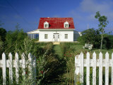 Cozy Cottage with a Red Roof and White Picket Fence